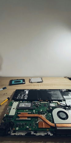a table with a laptop and headphones on it